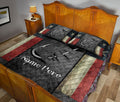 Angler-themed quilt blanket styled on a bedroom bed with fishing hook artwork and dark patriotic-inspired colors