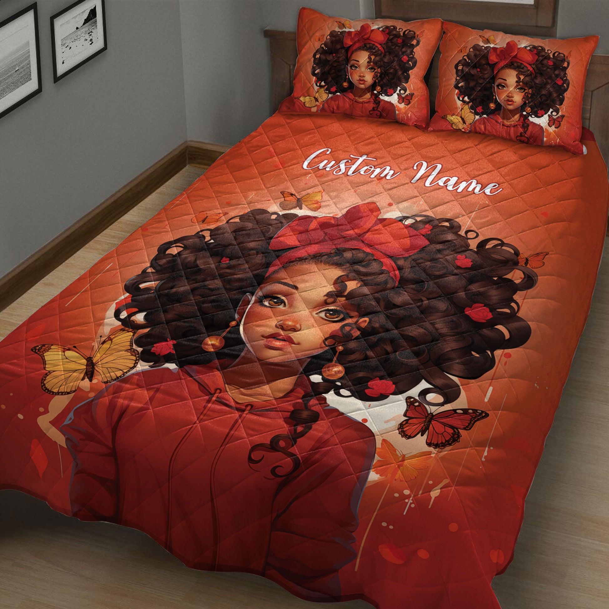 Close bedroom view of a red quilt blanket featuring a Black girl portrait, curly hair, roses, and butterflies