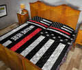 Firefighter quilt blanket styled in a bedroom with patriotic red, black and white artwork