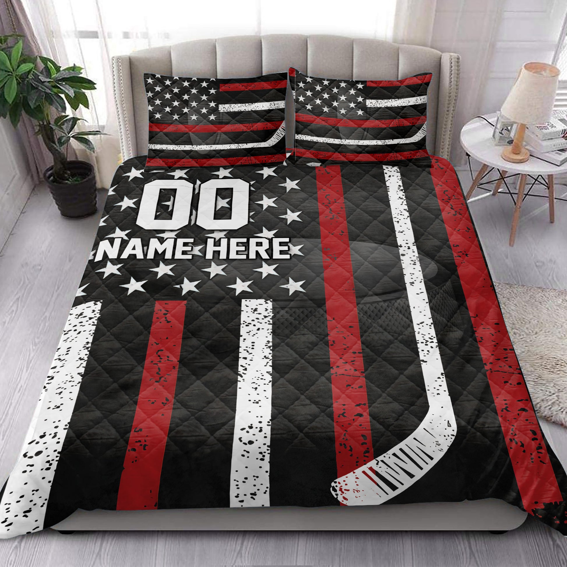 Hockey quilt blanket styled on a bedroom bed with bold red, white, and black hockey graphics