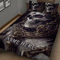Close view of a skull quilt blanket featuring skeletal artwork in black, gray and bronze tones
