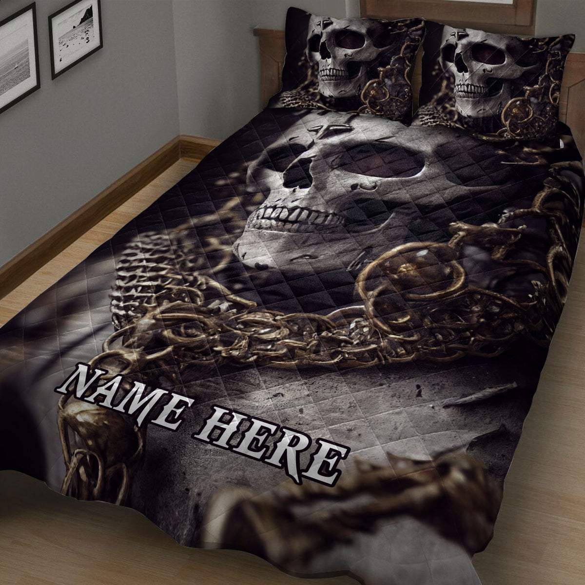 Close view of a skull quilt blanket featuring skeletal artwork in black, gray and bronze tones