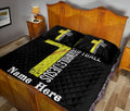 Softball quilt blanket styled across a bedroom bed with bold yellow sports artwork