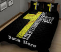 Black softball quilt blanket on a bed featuring yellow softball graphics and bold white typography