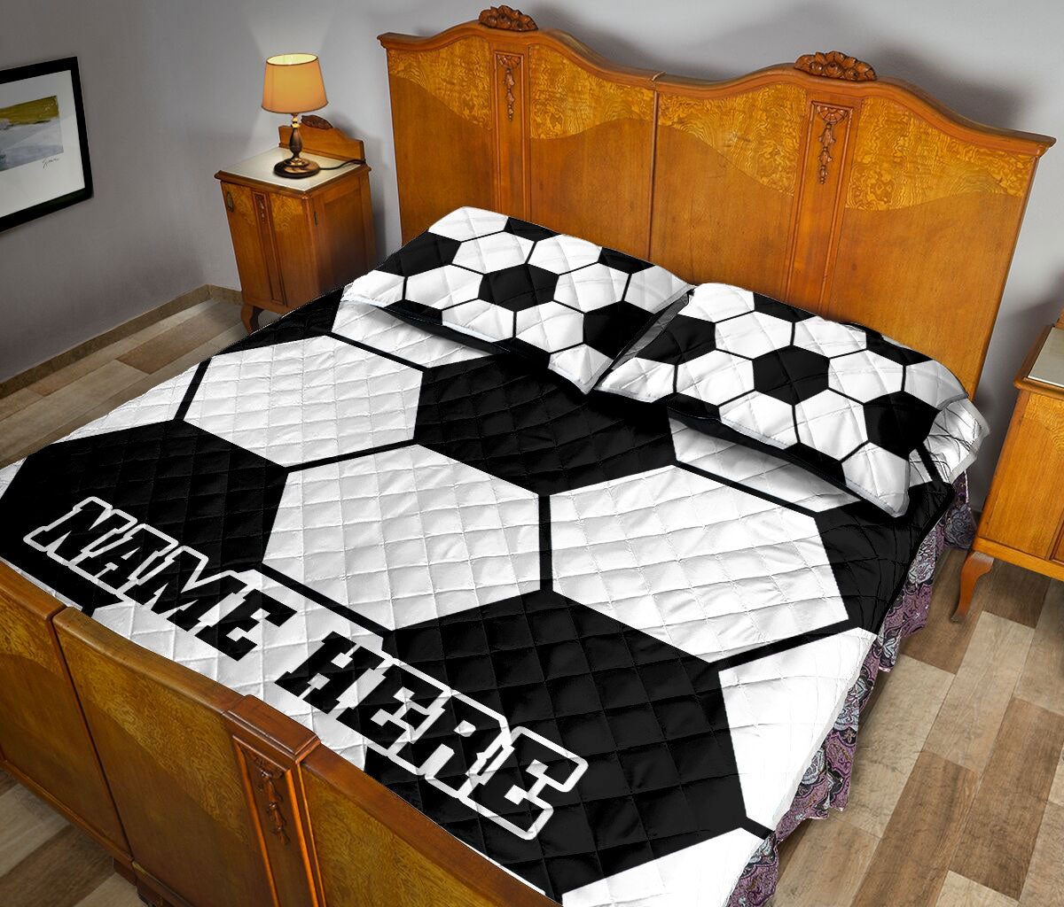 Black and white soccer ball bedding styled across a bedroom bed with matching pillows