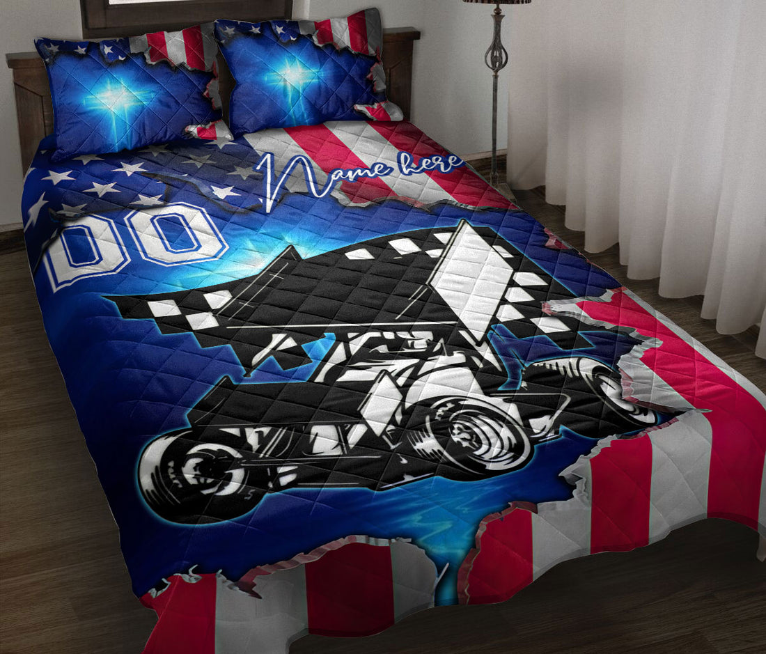 Dirt track racing quilt blanket displayed on a bed with a sprint car, checkered accents, and patriotic red, white, and blue artwork
