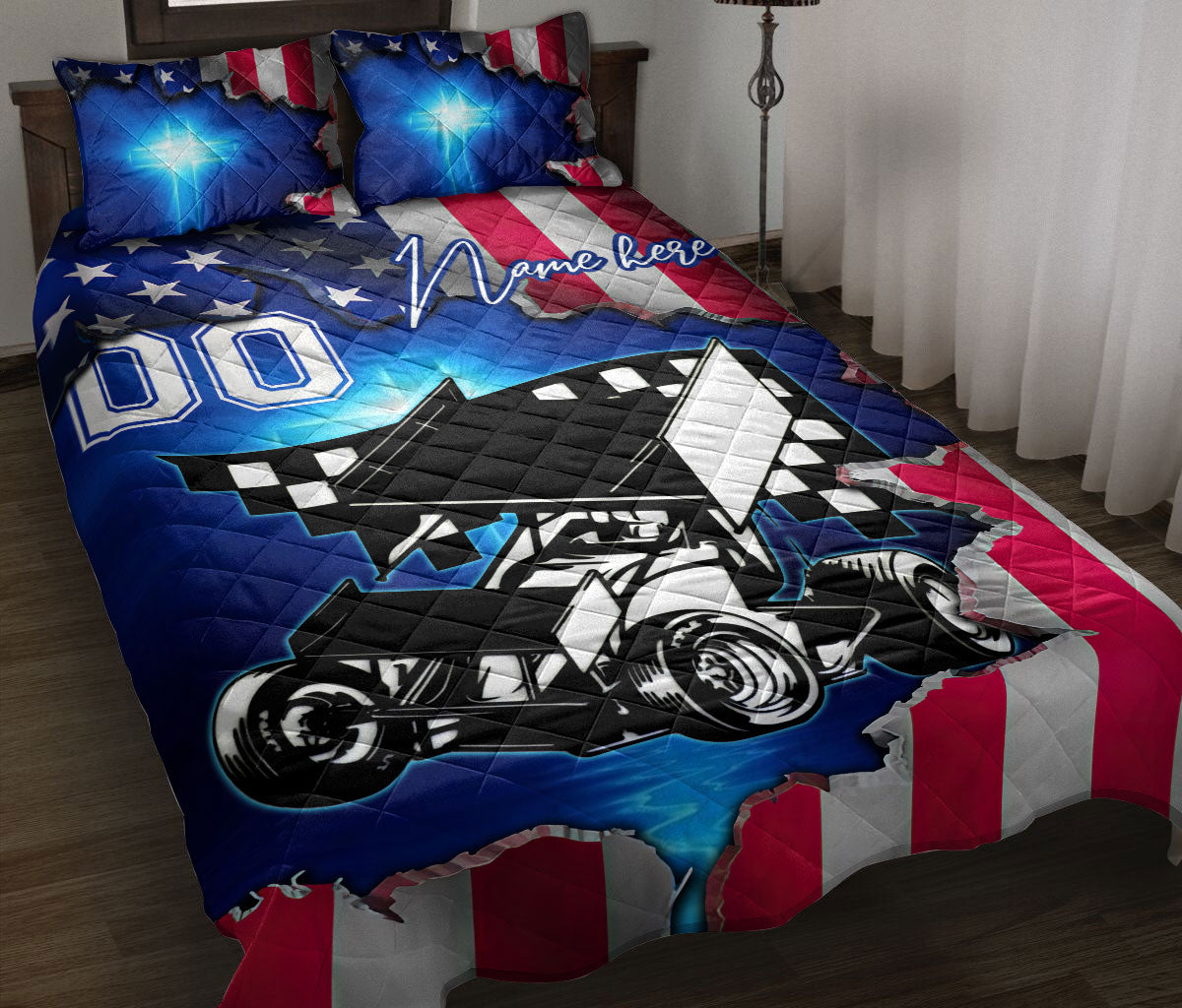 Dirt track racing quilt blanket displayed on a bed with a sprint car, checkered accents, and patriotic red, white, and blue artwork