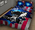 Racing quilt blanket on a bed with a black and white sprint car, blue highlights, checkered accents, and patriotic colors