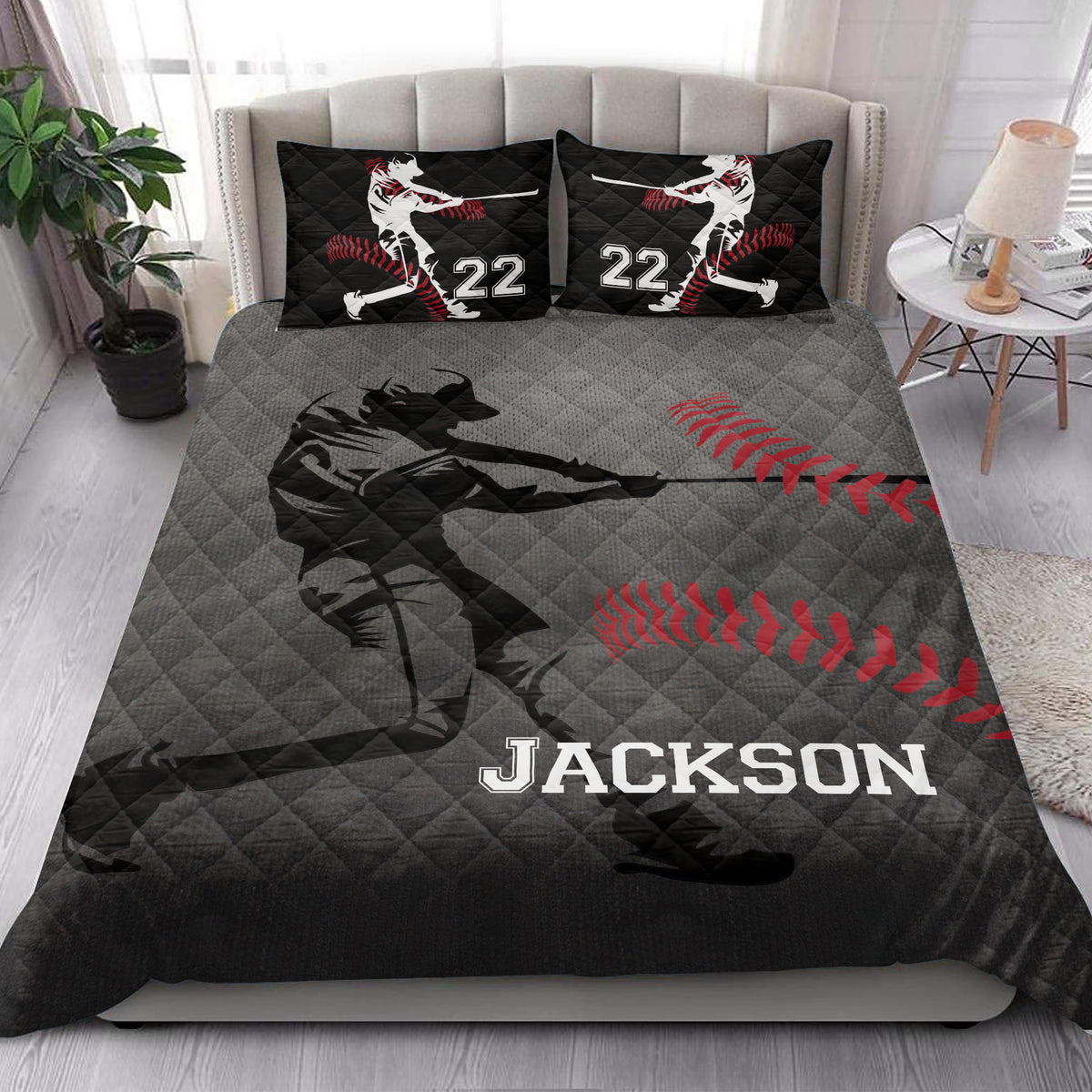 Baseball quilt blanket styled in a bright bedroom with dramatic batter artwork and red and black sports colors