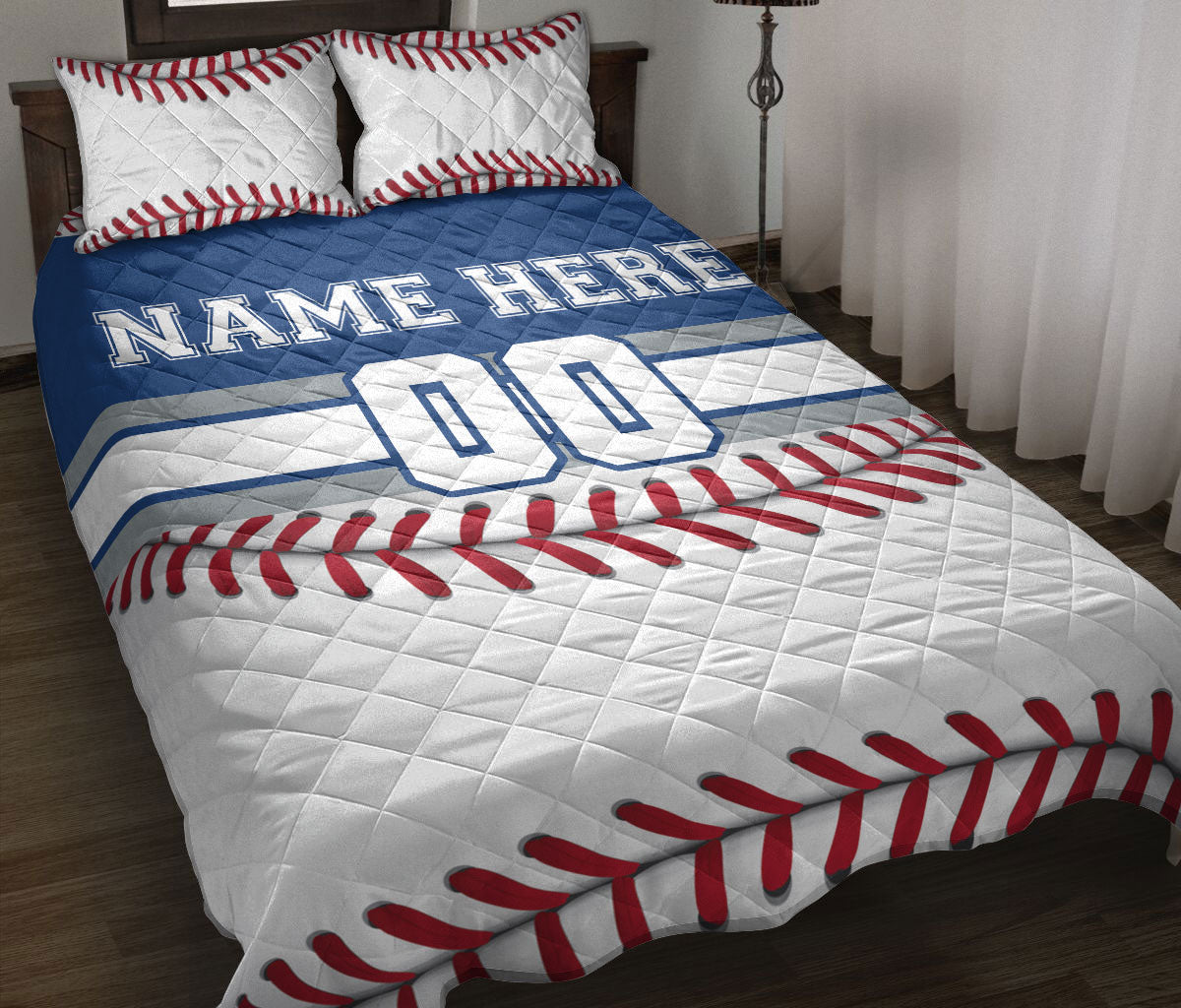 Baseball quilt blanket styled on a bed with red stitching, blue jersey stripes, and bold sports artwork