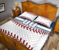 Baseball quilt blanket displayed in a bedroom with red stitching artwork and blue athletic accents
