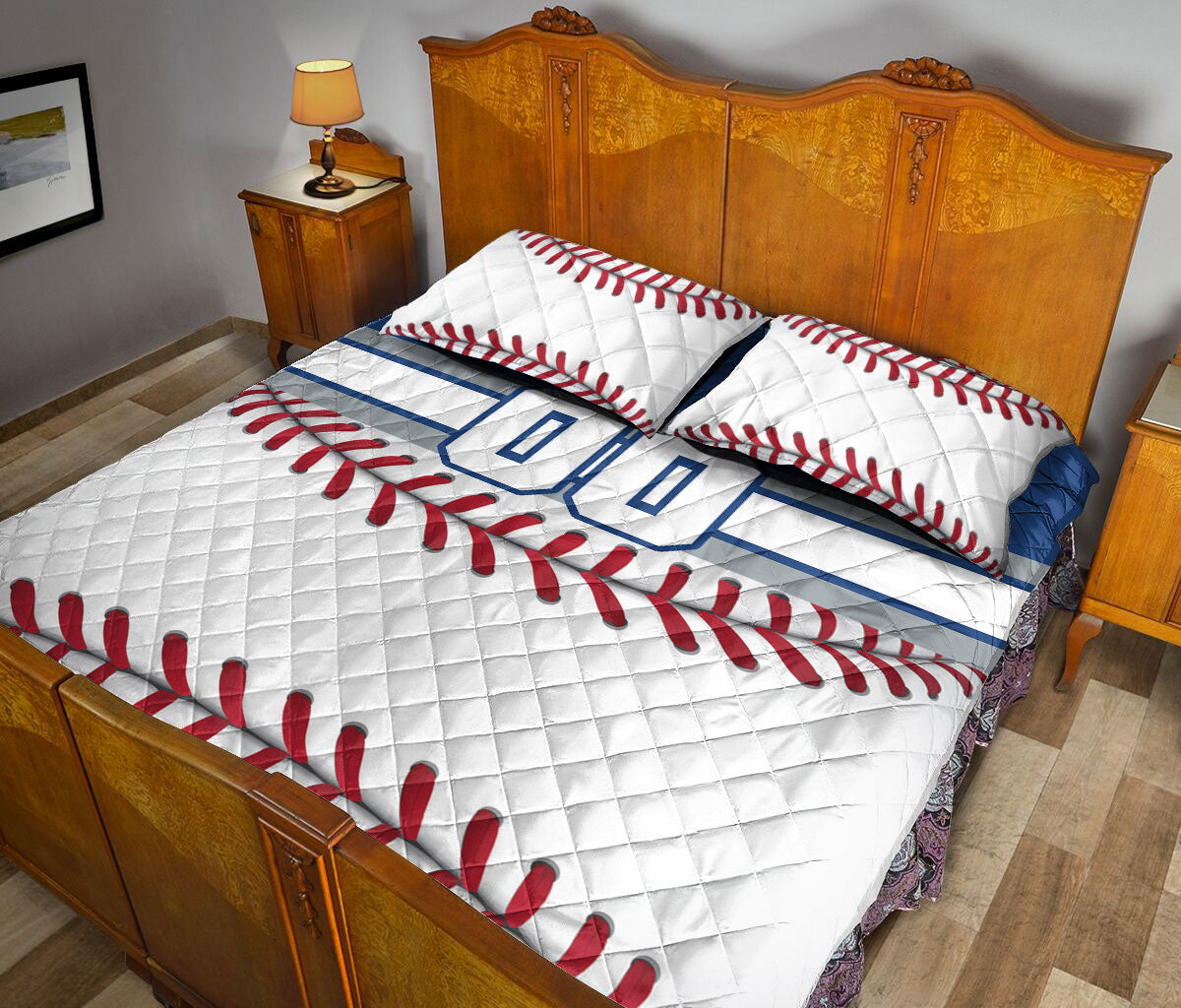 Baseball quilt blanket displayed in a bedroom with red stitching artwork and blue athletic accents