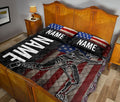 Patriotic baseball quilt blanket styled across a bedroom bed with batter artwork and bold red, white, and blue decor