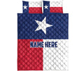 Texas flag quilt bed set shown flat with a large white Lone Star and coordinating red, white, and blue pillow designs