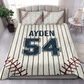 Baseball quilt blanket styled in a bright bedroom with pinstripes, red stitching, and navy varsity sports graphics
