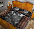 Rustic hunting quilt blanket styled on a wooden bedroom bed with large antler artwork and patriotic accents