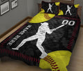 Close bedroom view of softball quilt bedding with batter silhouette, yellow softball graphics, and black sports design