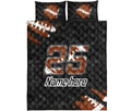 Flat lay view of a football quilt bedding set with football graphics and bold black and orange design