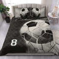 Black and white soccer ball quilt blanket styled in a bright modern bedroom