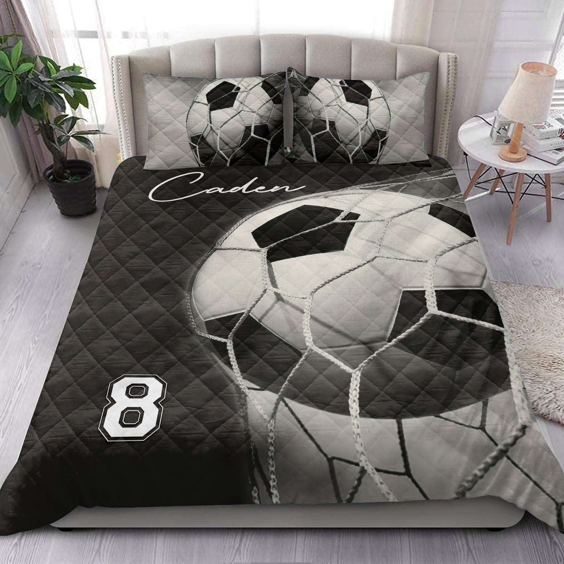 Black and white soccer ball quilt blanket styled in a bright modern bedroom