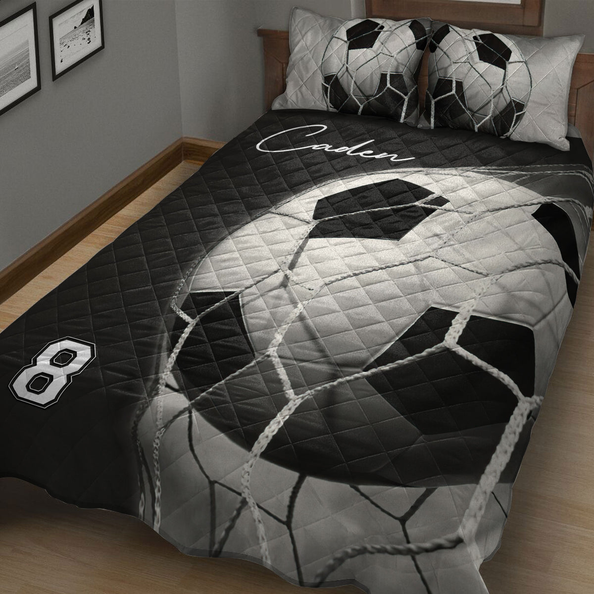 Close-up view of a black and white soccer ball quilt blanket with bold sports artwork