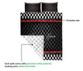 Racing quilt blanket lifted to show its white backing and stitched construction