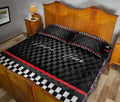Racing-themed quilt bedding displayed in a bedroom with black, white, and red checkered artwork