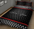 Black and red checkered racing quilt blanket styled on a bedroom bed