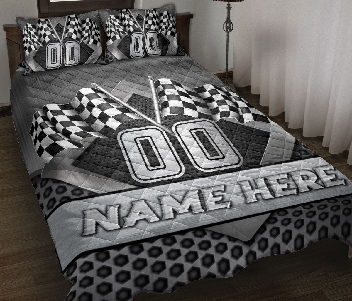 Custom racing quilt blanket displayed on a bed with checkered flags and bold black and gray motorsport artwork