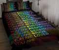 Rainbow affirmation quilt blanket styled on a bed with matching colorful affirmation pillow covers