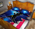 Softball quilt blanket styled on a bedroom bed with female batter silhouette and patriotic sports artwork