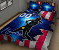 Patriotic softball quilt blanket displayed on a bed with female player silhouette and bright blue accents