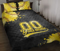 Black and gold softball quilt blanket styled on a bed with bold sports artwork