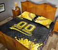 Black and gold softball quilt blanket presented in a traditional bedroom setting