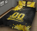 Bold black and gold softball quilt blanket with stitched ball artwork on a bed