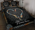 Black fishing quilt blanket displayed on a bed with heart-shaped hooks and ornate copper and teal borders