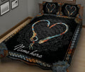 Black fishing quilt blanket with colorful heart-shaped hooks and mandala-inspired border in a bedroom setting