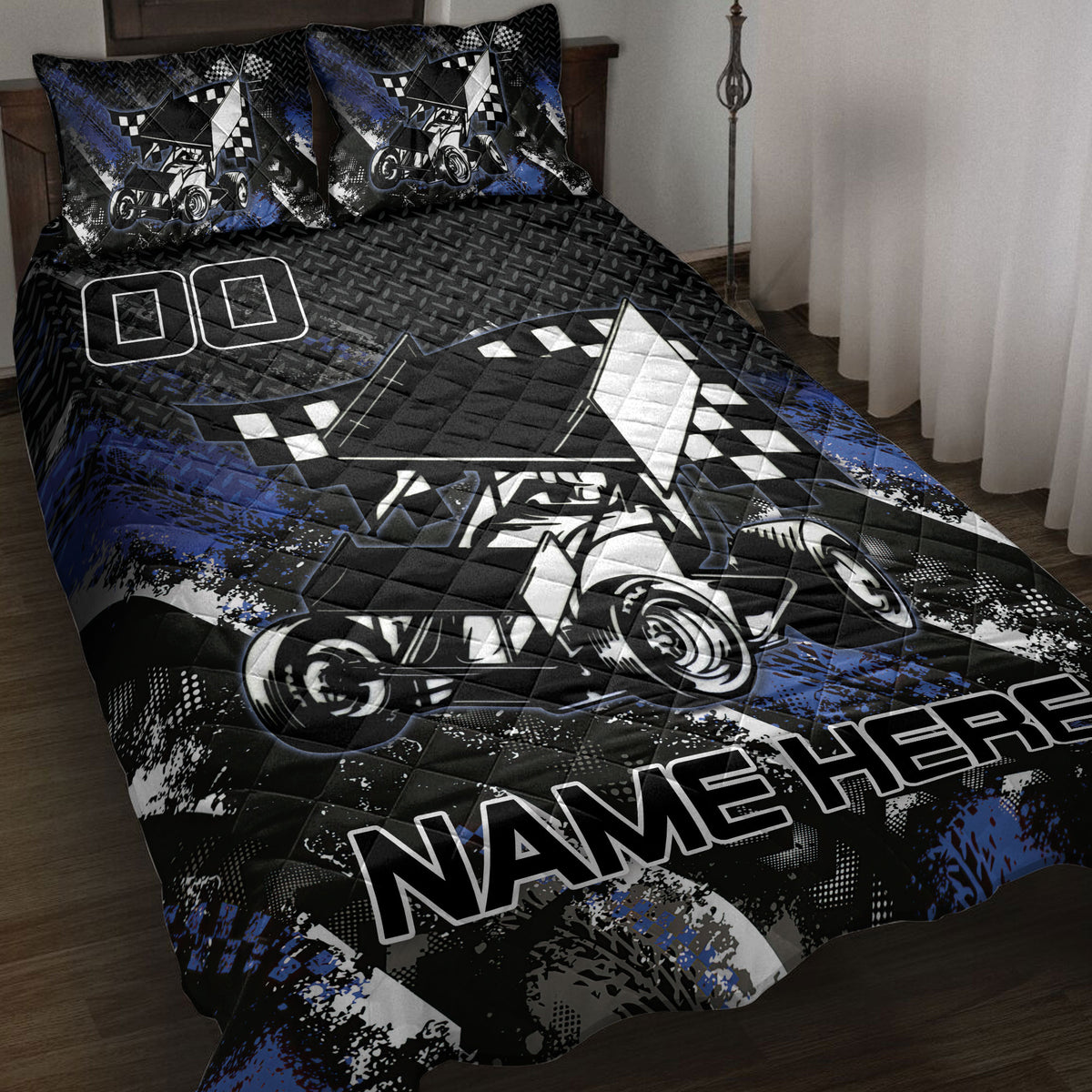 Dirt track racing quilt blanket displayed on a bed with sprint car artwork and black, blue, and white graphics